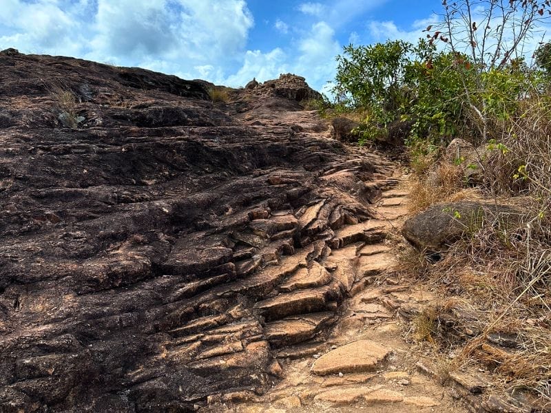 The climb up and over the rocks to the sign at Cape York
